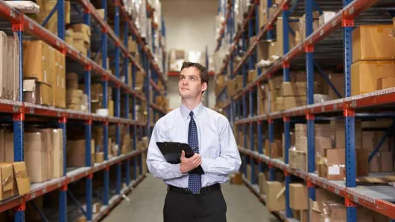 man-working-in-warehouse-with-tablet-and-looking-up