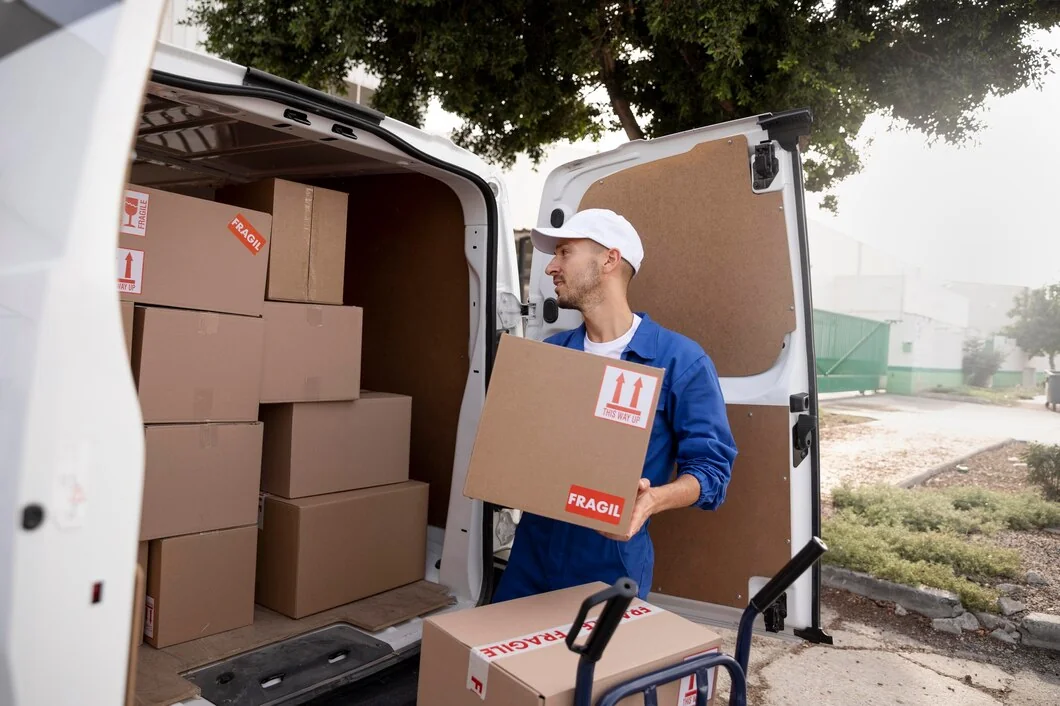delivery-worker-blue-uniform-white-cap-unloading-fragile-box-van-stacked-boxes