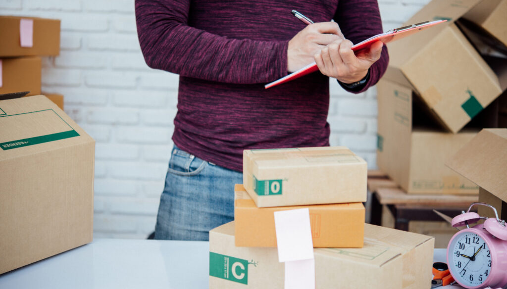 person-checking-packages-for-shipping