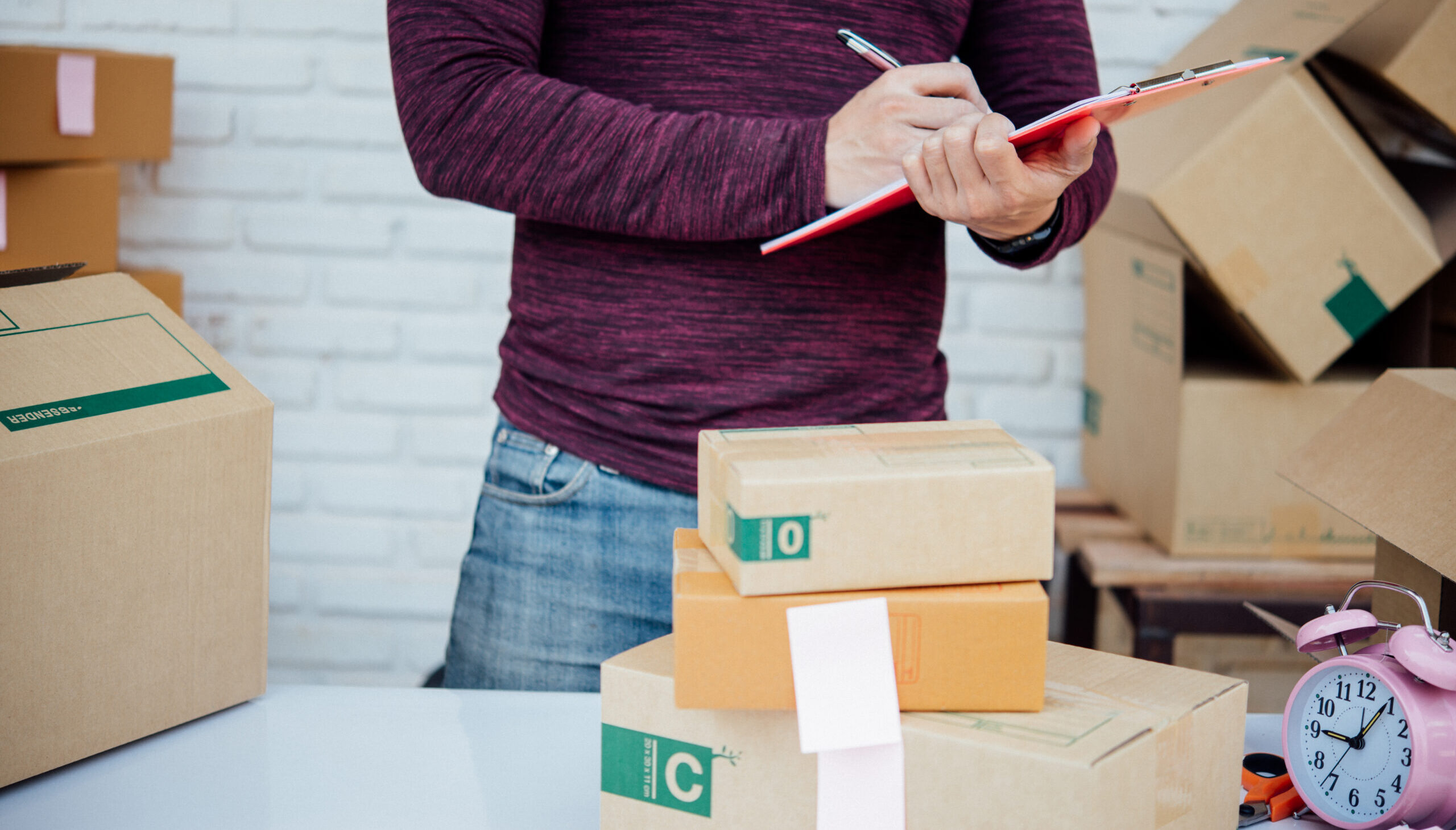 person-checking-packages-for-shipping
