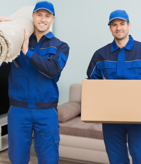 two-workers-moving-boxes-carrying-rug-smiling