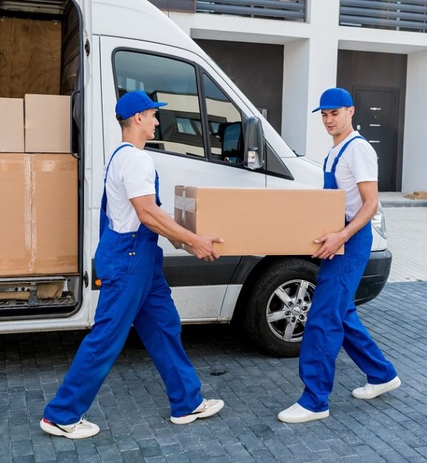 Two movers carrying boxes from the truck for unloadingmoving help Two movers carrying boxes from the truck for unloading